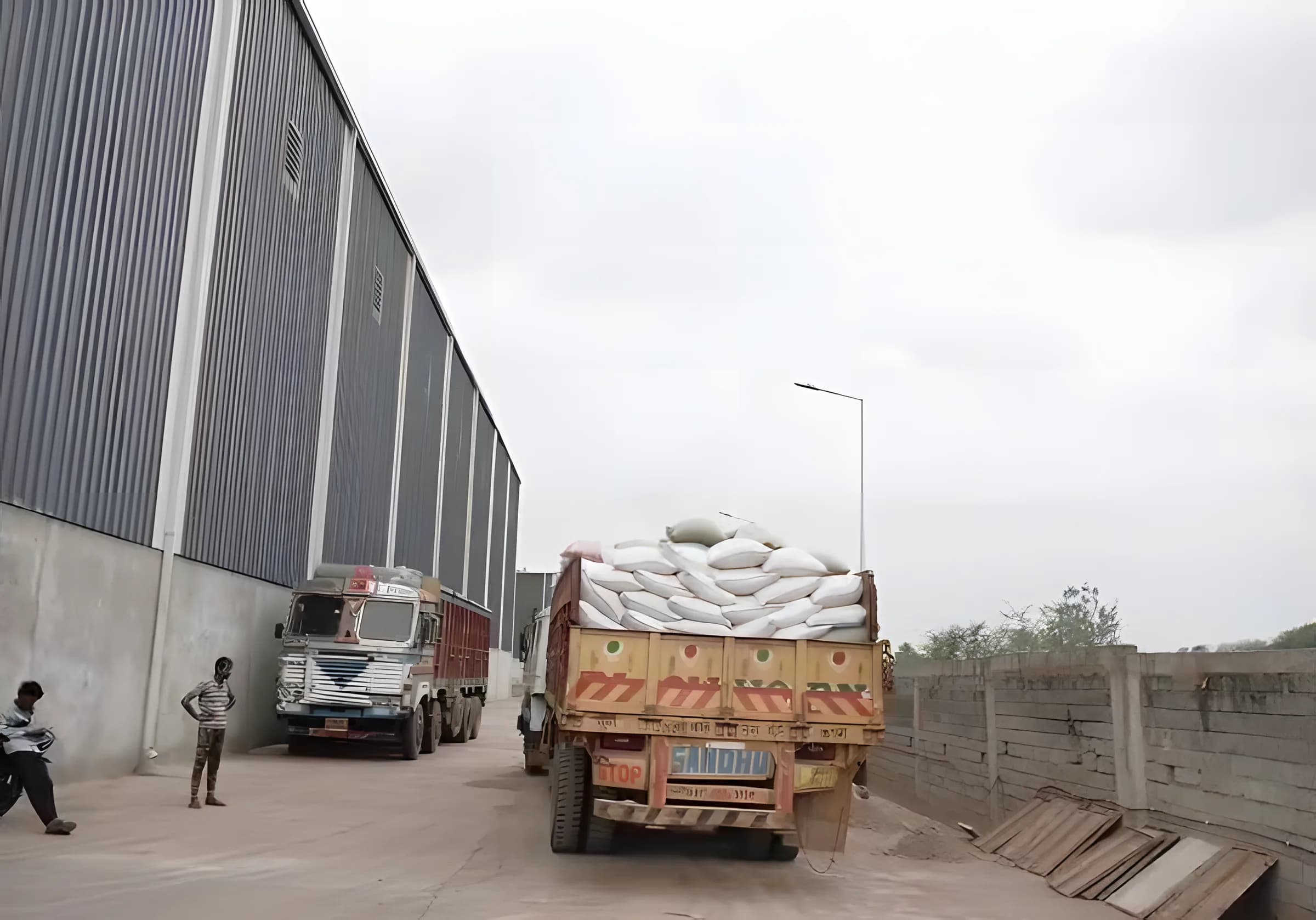 Trucks loaded with bags at the warehouse