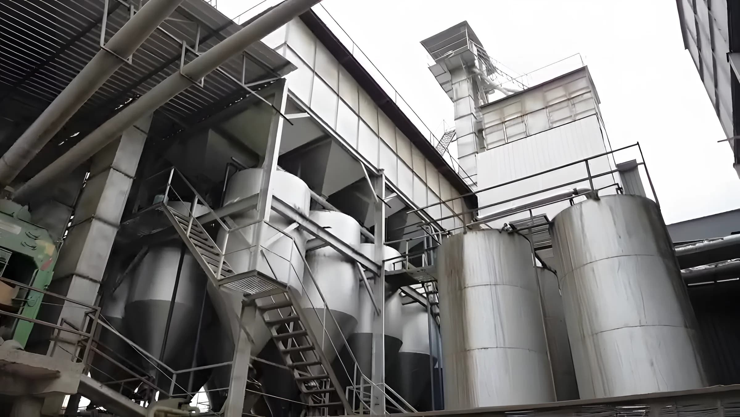 Steel storage silos and conveyors beside the plant